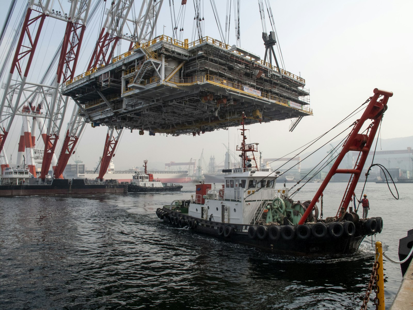 A heavy-lift crane barge lifting a large project cargo module