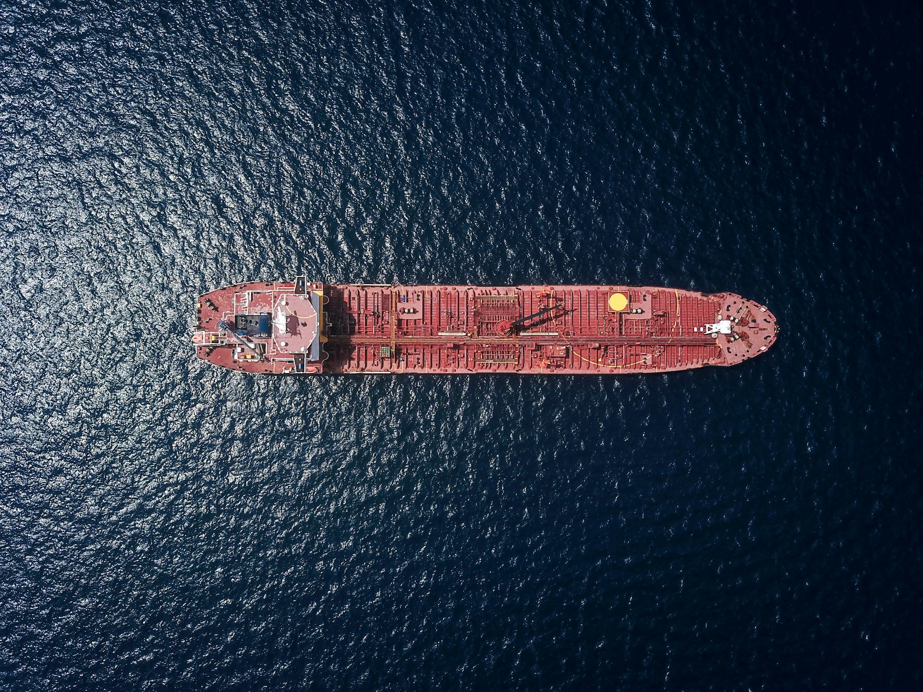 Directly overhead aerial view of a tanker vessel at sea
